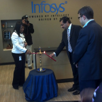 The traditional Indian ceremony of "lighting the lamp" is conducted by India's Consul General Ajit Kumar (center), overseen by Infosys BPO's COO Ritesh Idnani (right)
